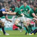 Stephen Ferris breaks through Imanol Harinordoquy as his jersey is torn by Vincent Debaty 4/3/2012