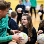 Collins Makes Special Delivery of School Footballs