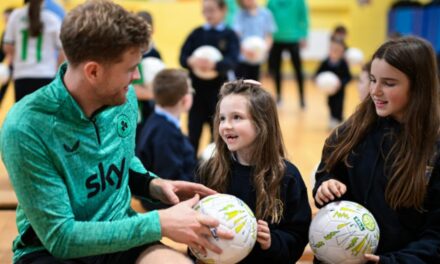 Collins Makes Special Delivery of School Footballs