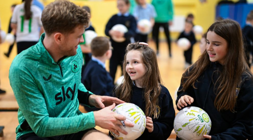 Collins Makes Special Delivery of School Footballs